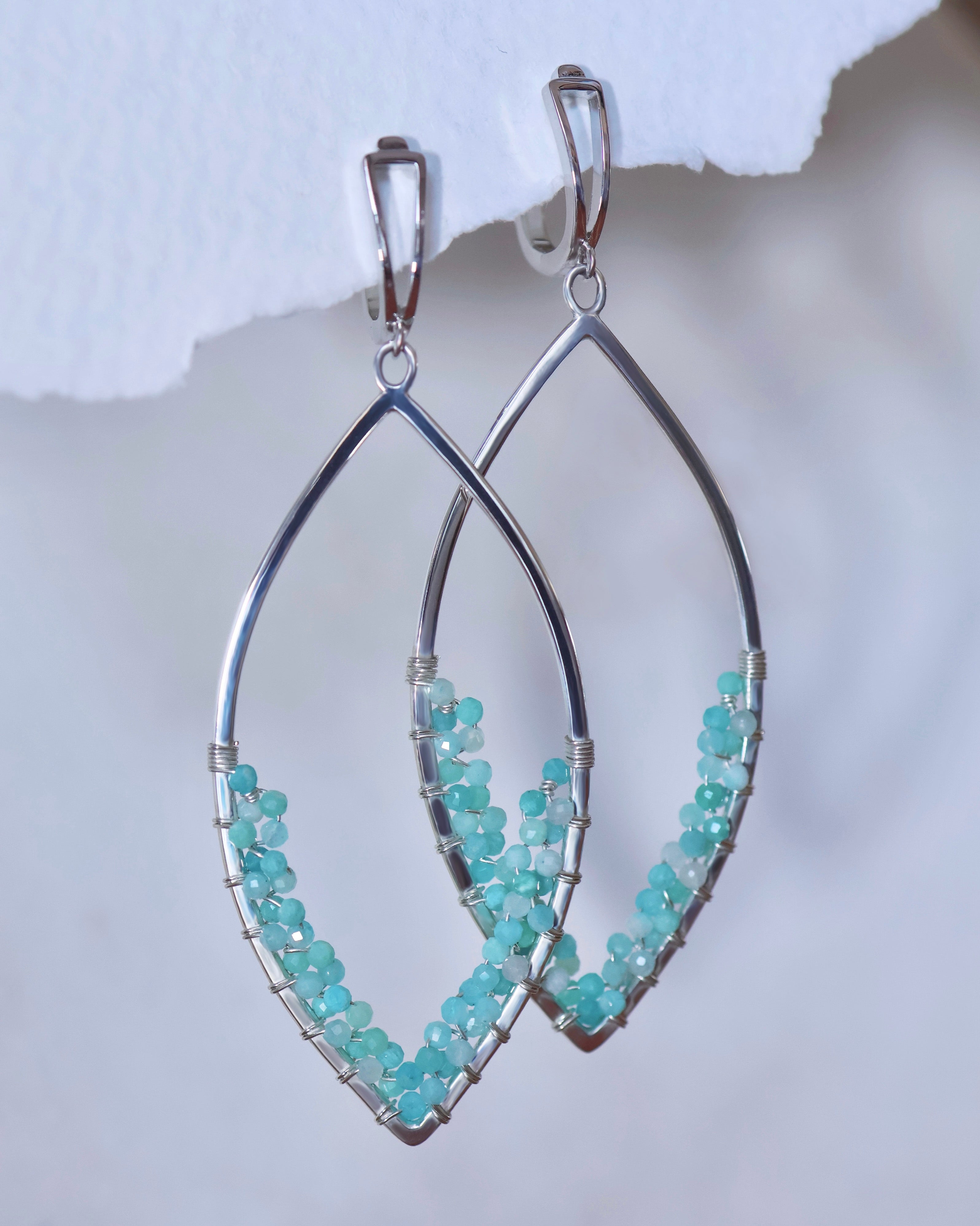 Lilac Sky Studio's Amazonite Earrings feature sterling silver marquise shapes adorned with clusters of handwoven Amazonite gemstone beads along the lower curve.