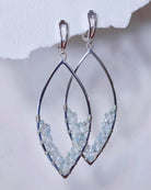 Aquamarine Earrings by Lilac Sky Studio: Sterling Silver marquise-shaped earrings featuring small aquamarine gemstone beads on the lower curve, finished with secure lever-back ear wires.